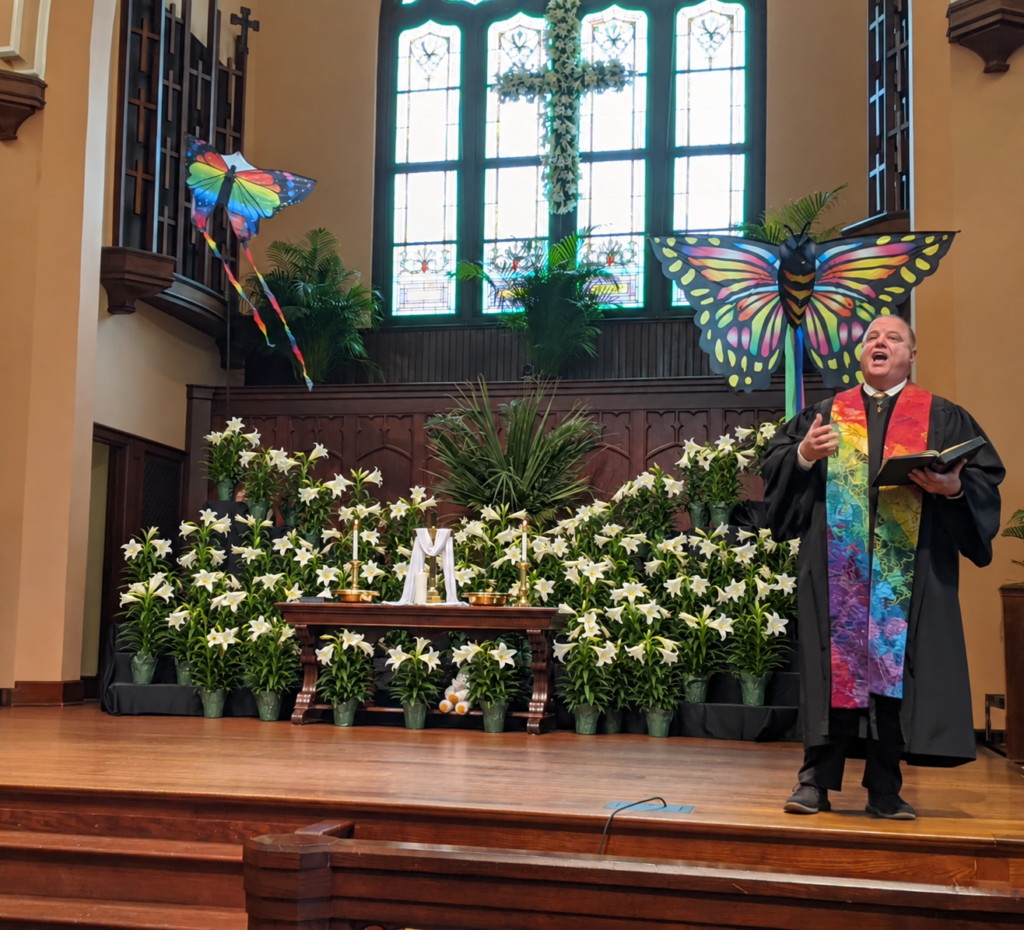 White lilies arranged around the altar in the Asbury Memorial Church sanctuary