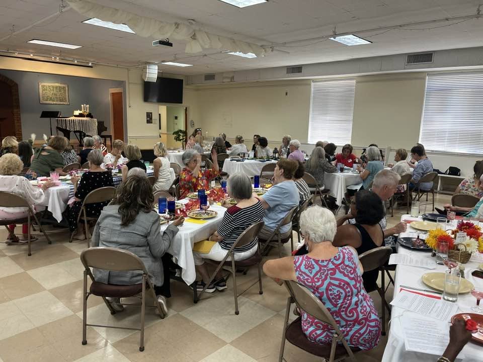 People seated together at round tables during an Asbury Memorial Church Sisters in Faith luncheon