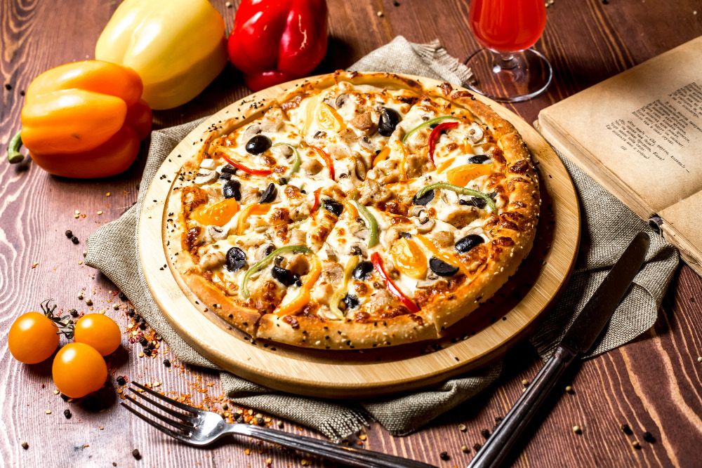 Pizza topped with olives and peppers